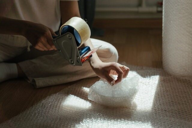 Innovative Packing Solutions 1 A person wrapping an object into bubble wrap