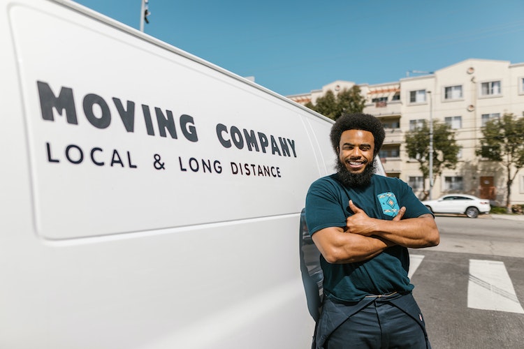 Man standing in front of moving company van